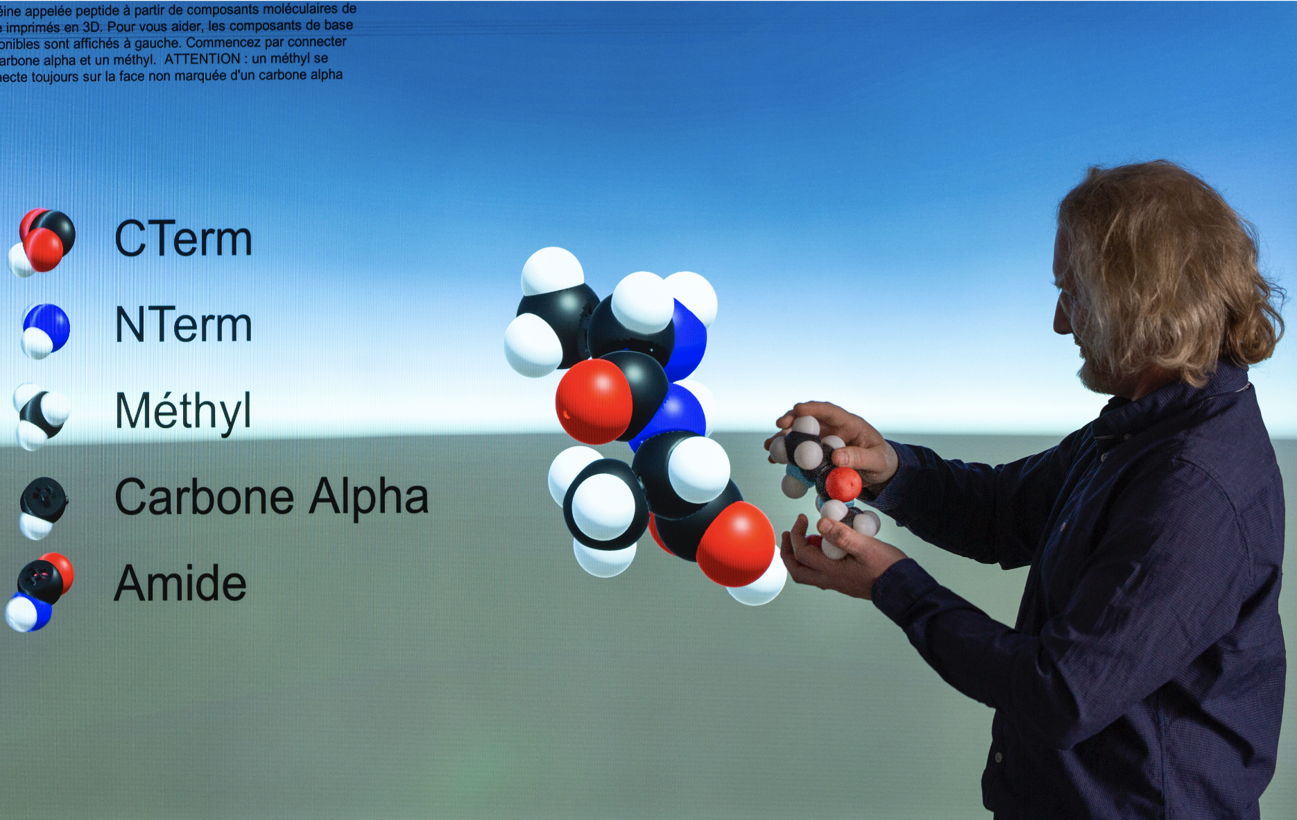 A user building and manipulating our tangible molecular interface and its synchronized virtual twin